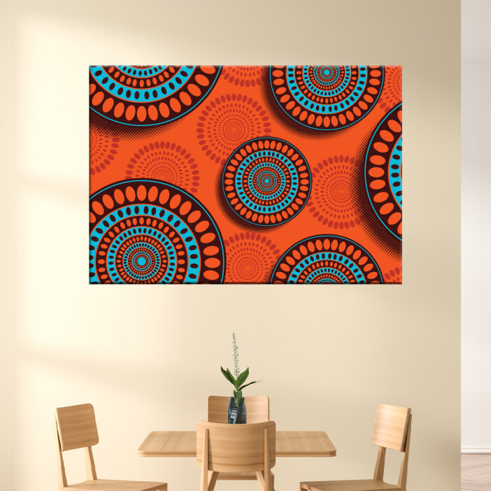 Tableau motifs africains orange et bleu. Bonne qualité, original, accrochée sur un mur au-dessus d'une table dans une maison