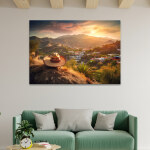 Tableau Mexique vue d'un paysage typique avec sombrero affiché dans un salon, avec poutres claires au plafond, au-dessus d'un canapé vert clair à coussins gris devant lequel se trouve une table basse.